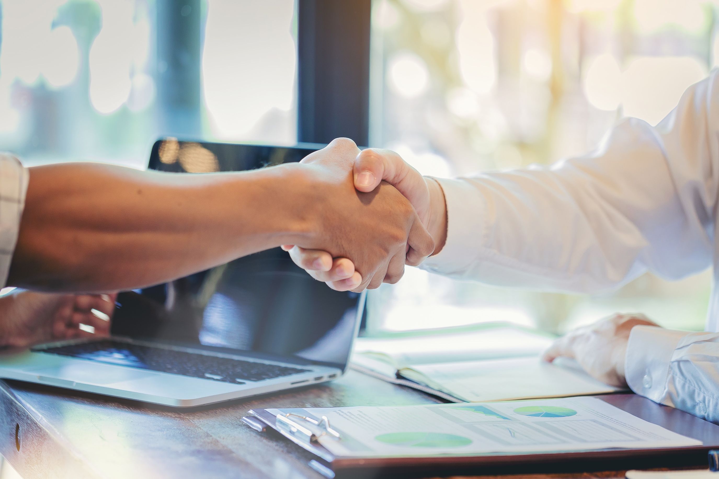 Businessman handshake at business meeting after negotiations with business partners.