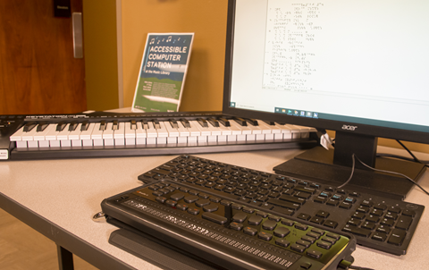 Braille display, MIDI keyboard, and desktop computer station for accessible music.