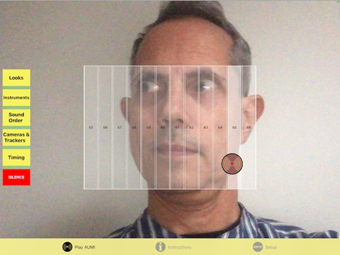 AUMI display showing camera feed of the user with boxes placed along the visual field assigned to different sounds. A cursor is controlled by gesture to activate each box on entry.