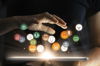 hand over digital tablet with icons of different marketing tools floating