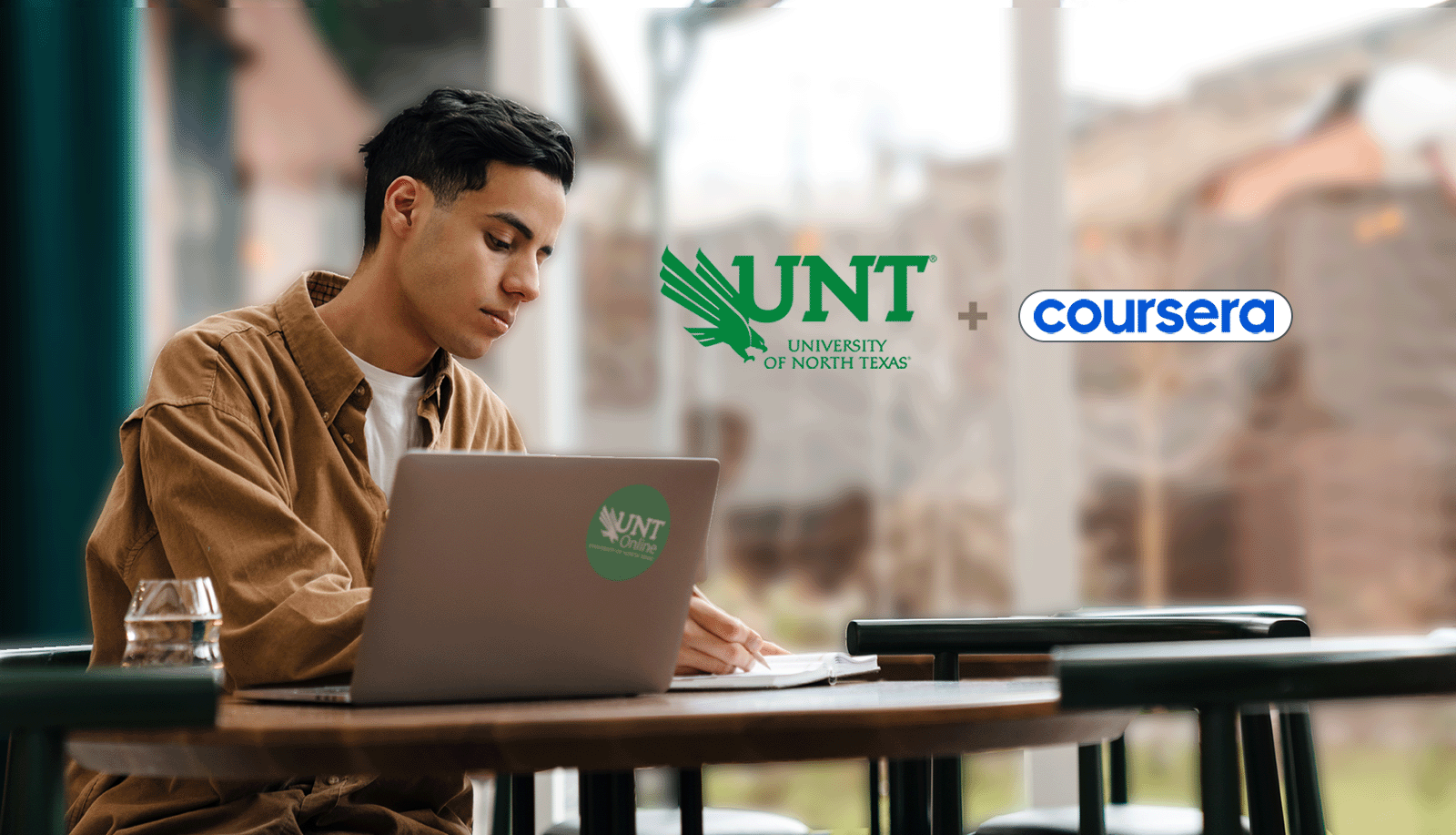 Person learning at their laptop with a notebook, and the UNT + Coursera Logo