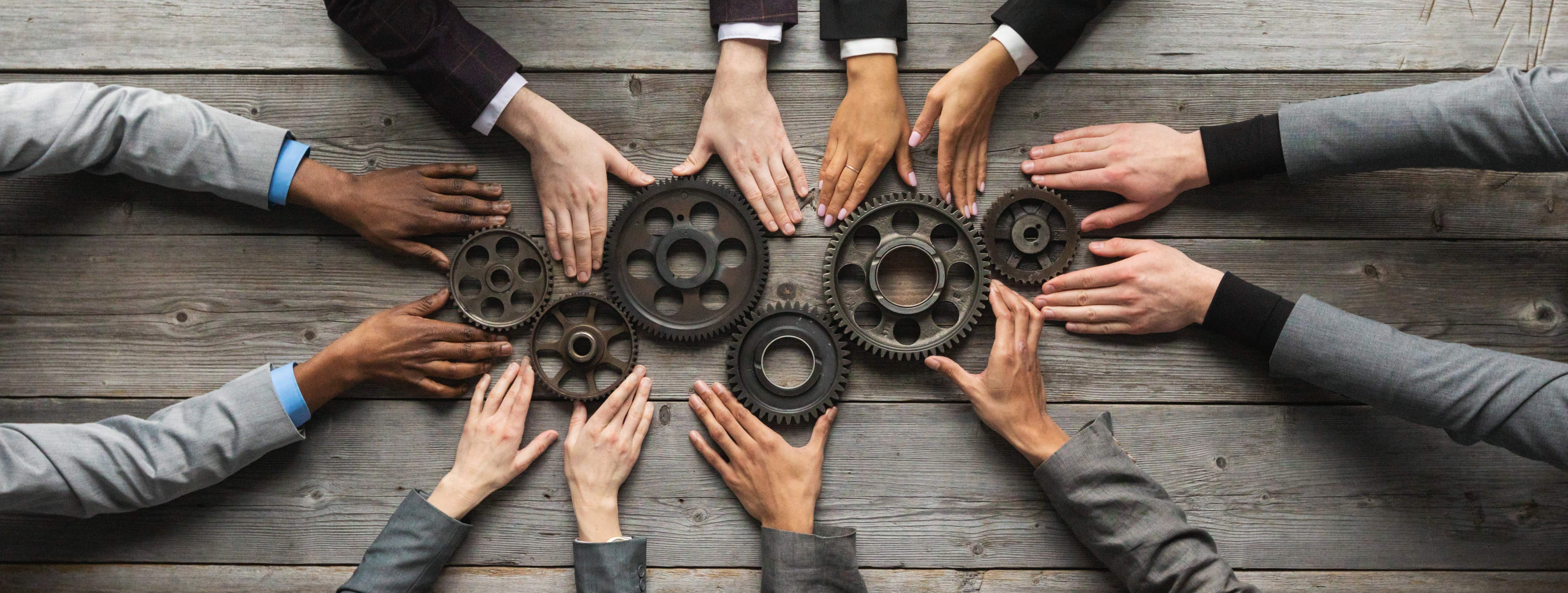 different hands on gears in the middle