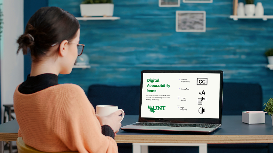 Female learner sits holding coffee mug in front of a laptop.