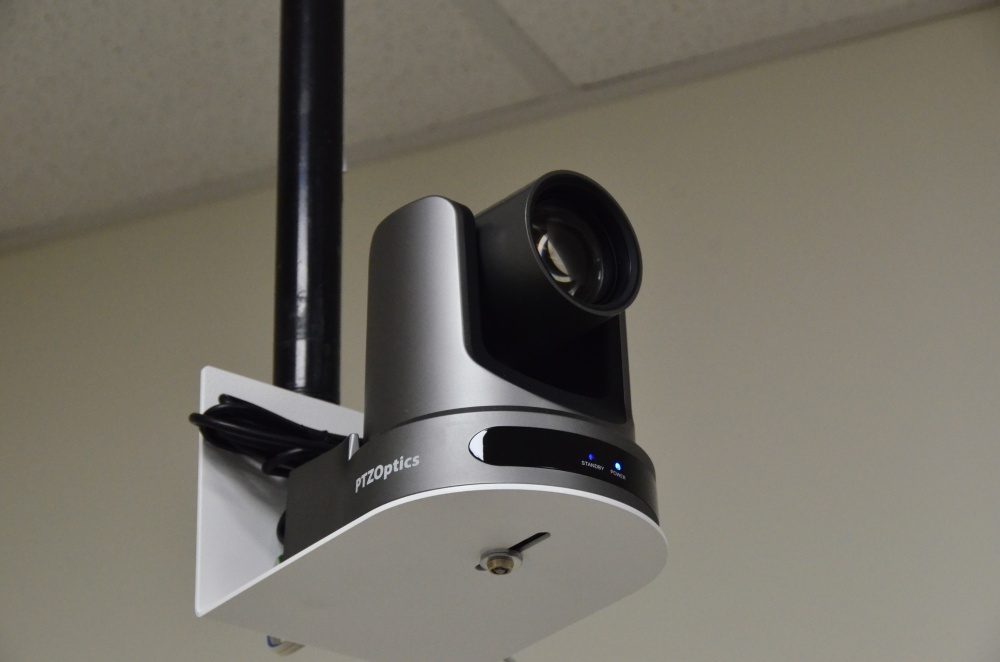 PTZ camera mounted on a pole suspended from the ceiling