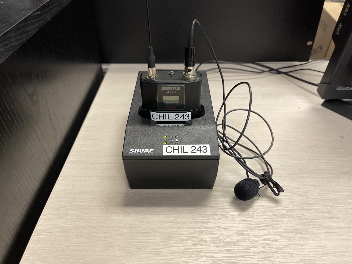 Wireless transmitter with mic docked in a charger