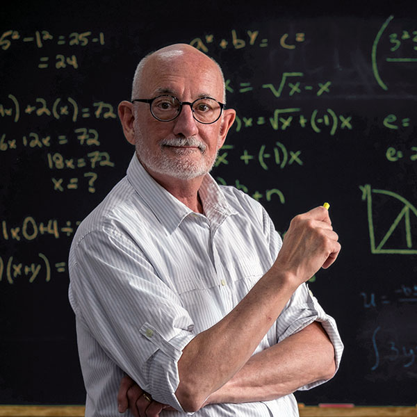Instructor in front of a chalkboard